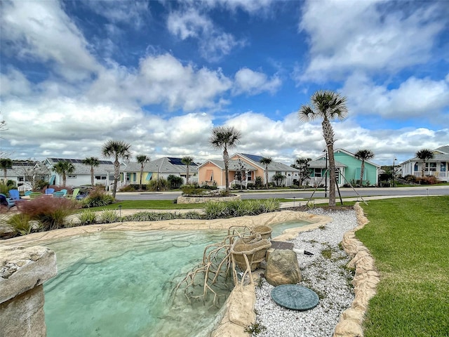 view of pool featuring a yard