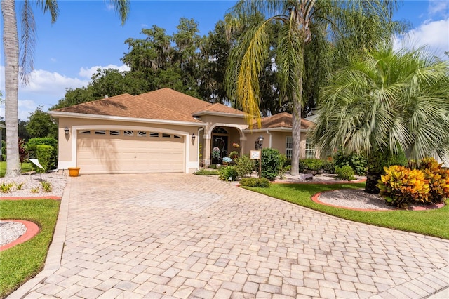 mediterranean / spanish-style house with a garage