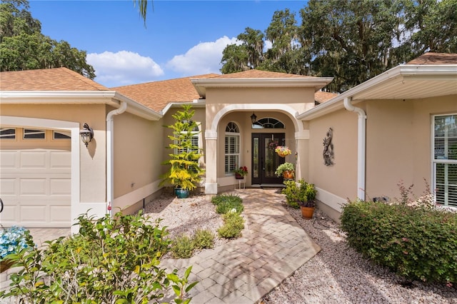 doorway to property with a garage