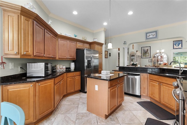 kitchen with sink, dark stone countertops, hanging light fixtures, stainless steel appliances, and crown molding