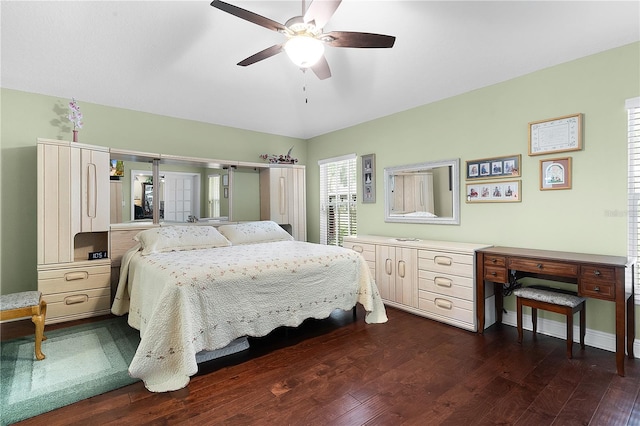 bedroom with dark hardwood / wood-style floors and ceiling fan