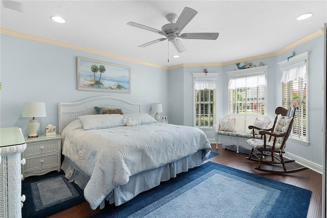 bedroom featuring crown molding, dark wood-type flooring, and ceiling fan