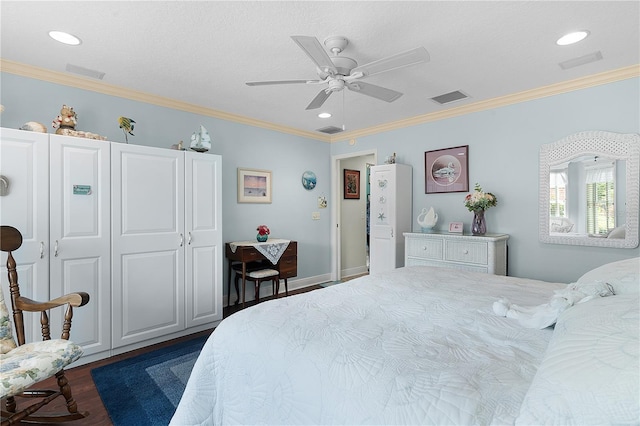 bedroom featuring ornamental molding, dark wood-type flooring, ceiling fan, and a closet