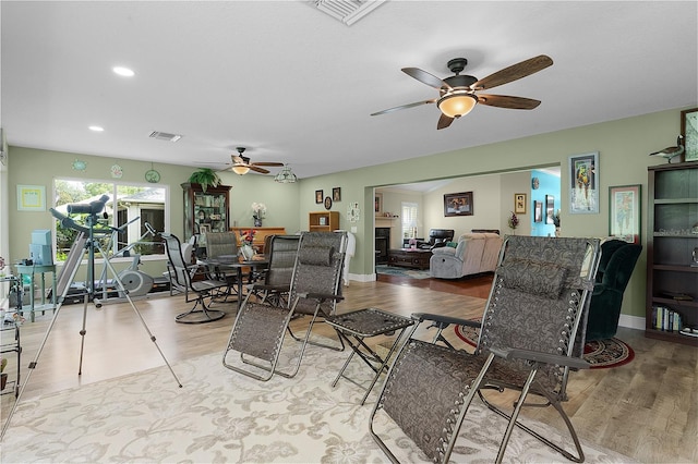 living room featuring ceiling fan and light hardwood / wood-style floors