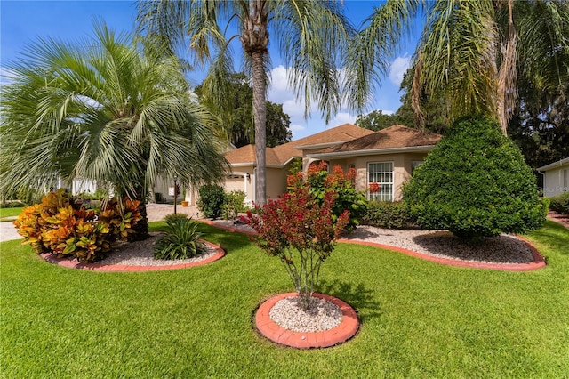 view of front of home with a garage and a front lawn