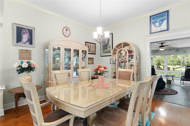 dining area featuring crown molding, wood-type flooring, and ceiling fan with notable chandelier