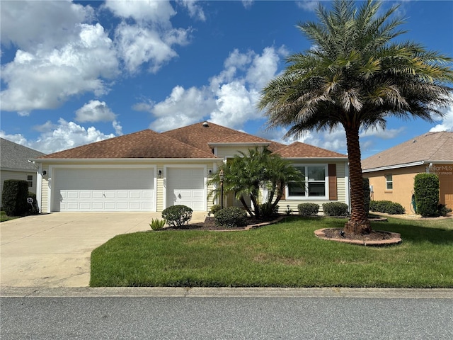 view of front of home with a garage and a front lawn