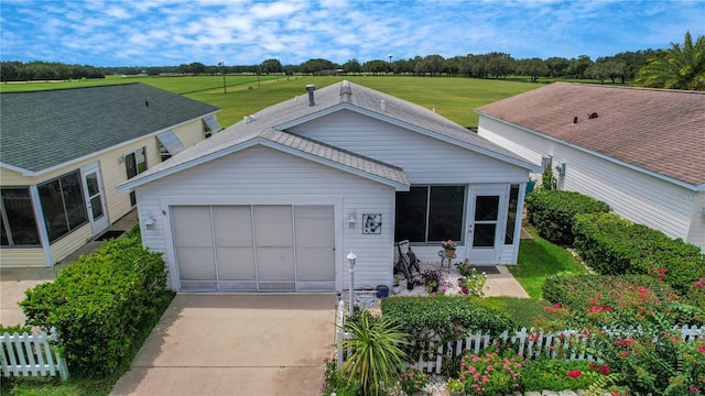 single story home featuring a garage and a front yard