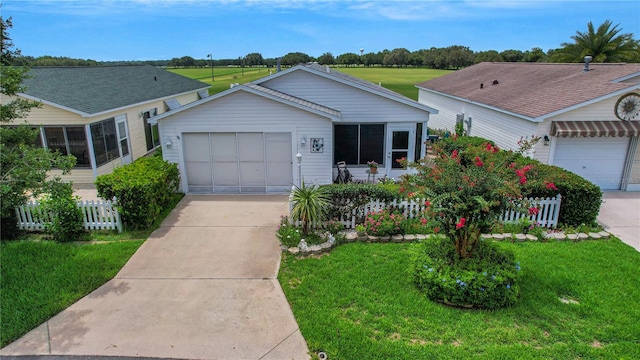 ranch-style house featuring a garage and a front lawn