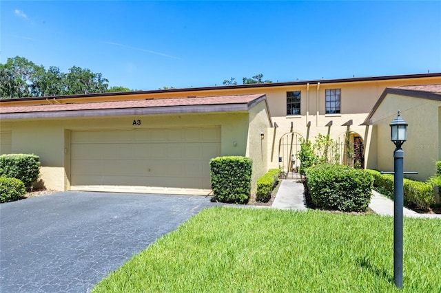 view of front of home with a garage and a front lawn