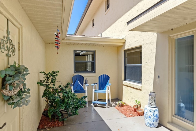 view of exterior entry with a patio