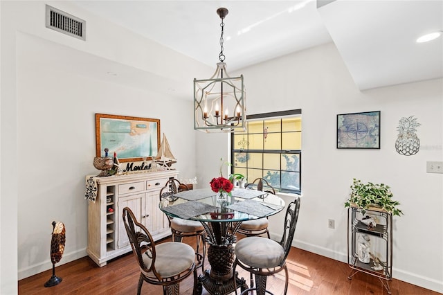 dining space featuring a chandelier and dark wood-type flooring