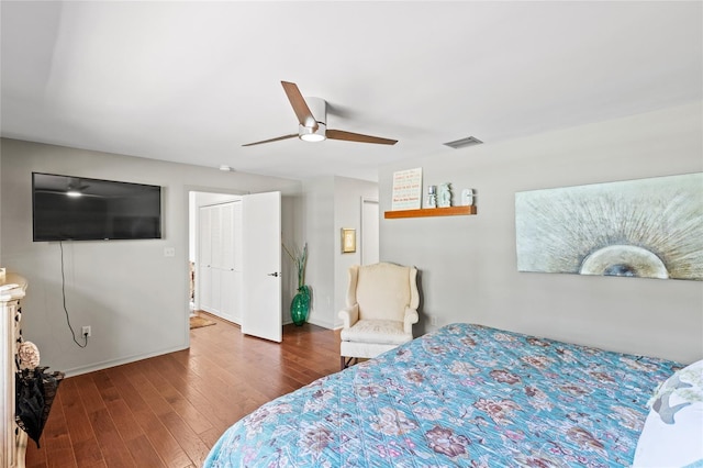 bedroom featuring a closet, ceiling fan, and dark hardwood / wood-style floors