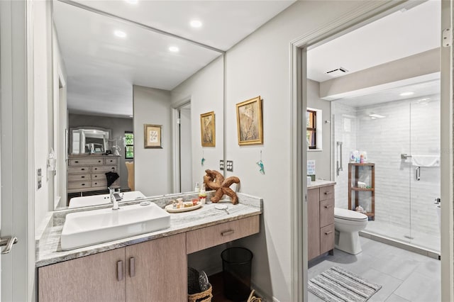 bathroom featuring vanity, toilet, tile patterned flooring, and walk in shower