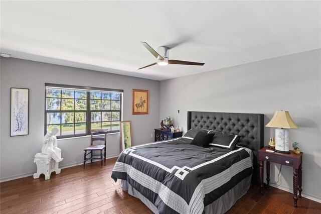 bedroom with dark hardwood / wood-style flooring and ceiling fan