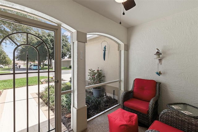 sunroom featuring ceiling fan