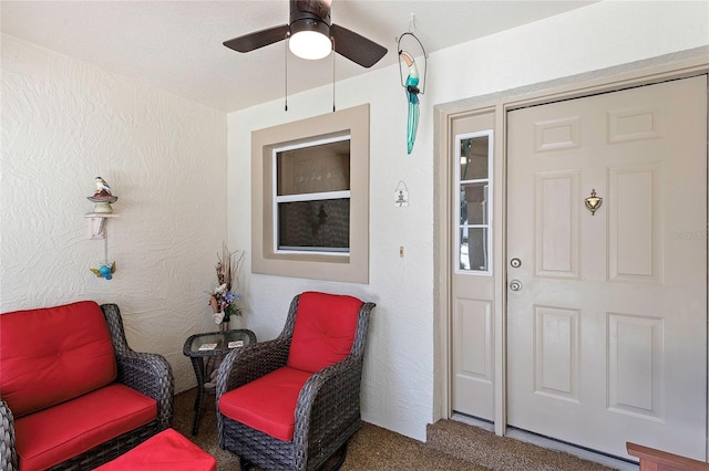 entrance to property with ceiling fan