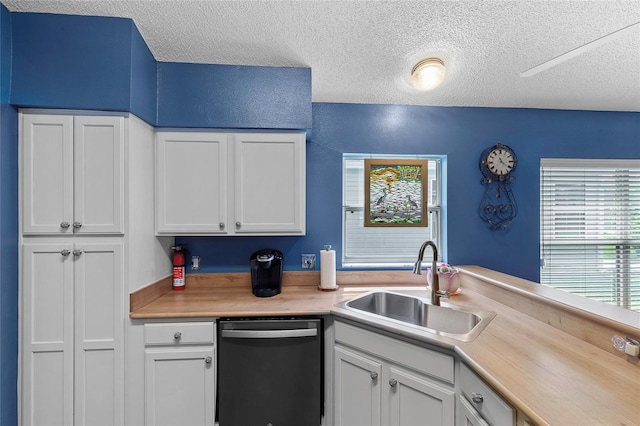 kitchen featuring white cabinetry, black dishwasher, sink, and a textured ceiling