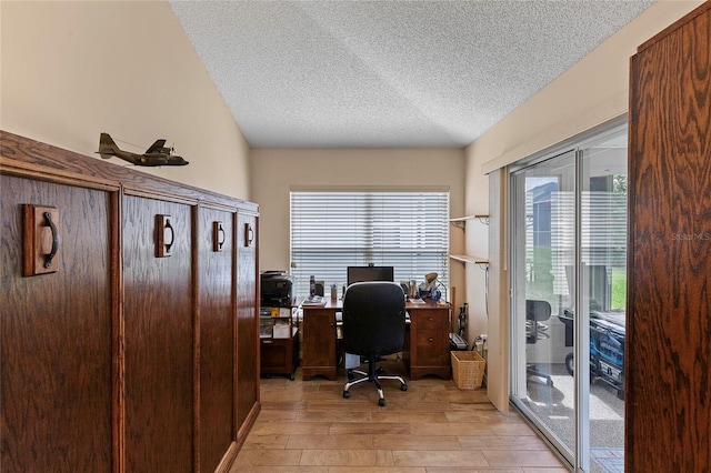 office featuring a textured ceiling and light hardwood / wood-style flooring