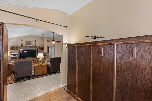 interior space with vaulted ceiling and light tile patterned floors