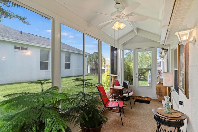 sunroom featuring ceiling fan and lofted ceiling with beams