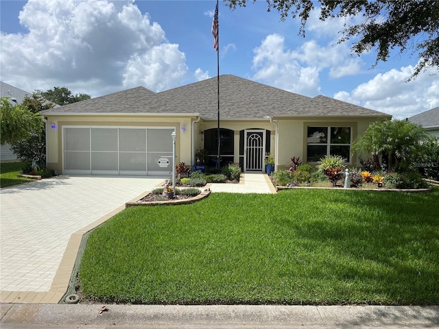 single story home featuring a garage and a front yard