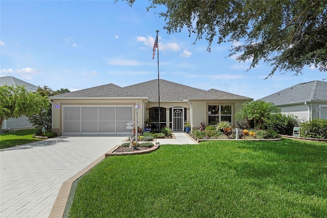 single story home featuring a garage and a front lawn