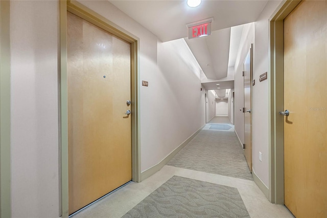 hallway with light colored carpet