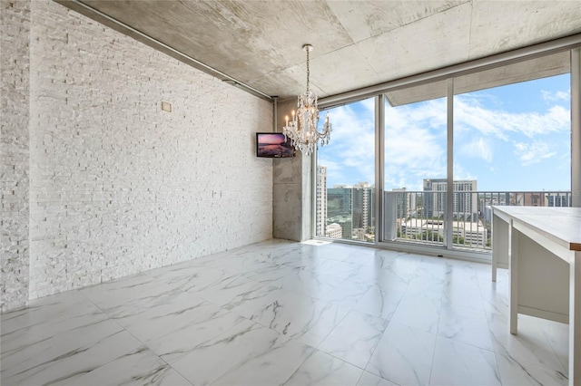 unfurnished dining area with a notable chandelier and floor to ceiling windows