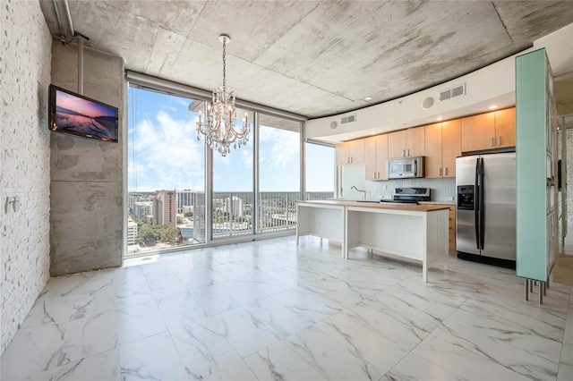 kitchen with a breakfast bar, appliances with stainless steel finishes, hanging light fixtures, floor to ceiling windows, and light brown cabinets