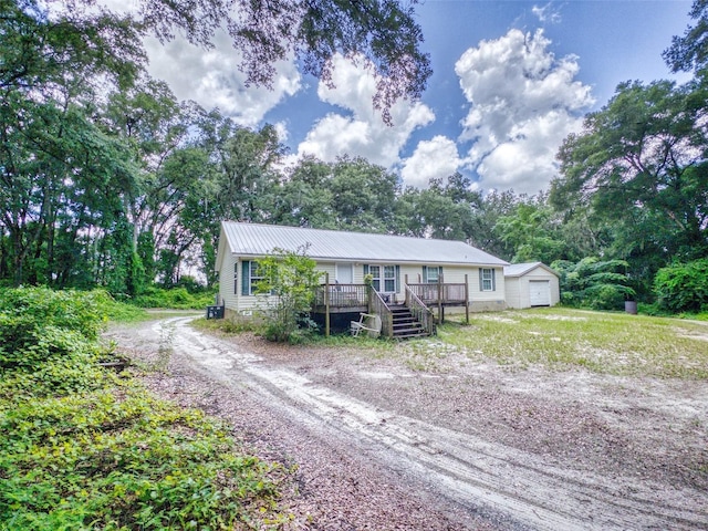 view of front of house with a garage and an outdoor structure