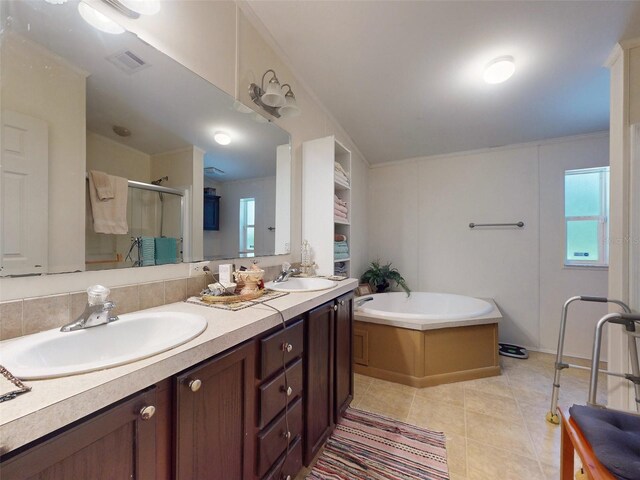 bathroom with plus walk in shower, dual vanity, and tile patterned flooring