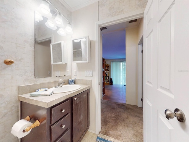 bathroom featuring vanity, crown molding, and hardwood / wood-style flooring