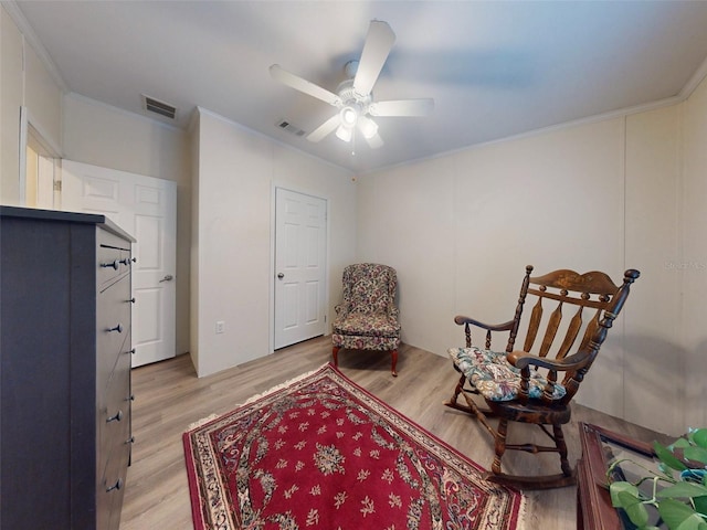 sitting room with ornamental molding, light hardwood / wood-style flooring, and ceiling fan