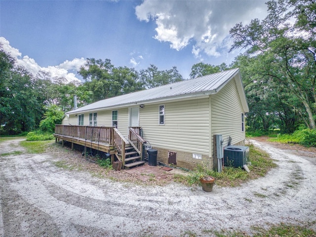 back of house featuring a wooden deck and cooling unit