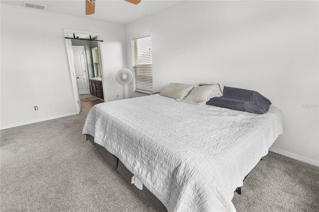 bedroom featuring connected bathroom, carpet floors, and ceiling fan