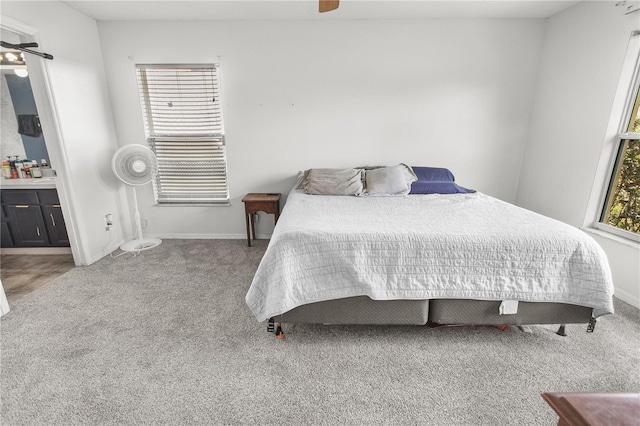 bedroom featuring ceiling fan, connected bathroom, and carpet floors