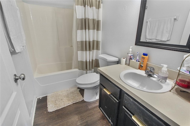 full bathroom with shower / bath combo, hardwood / wood-style floors, vanity, and toilet