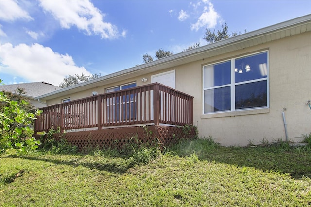 exterior space featuring a wooden deck and a yard