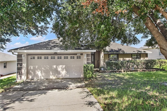 view of front of home with a garage and a front yard