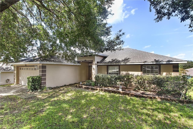 view of front of property featuring a garage and a front lawn