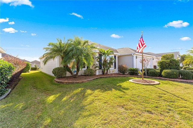 view of front of property with a front lawn and a garage