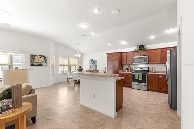 kitchen with appliances with stainless steel finishes, vaulted ceiling, light tile patterned floors, decorative light fixtures, and a notable chandelier