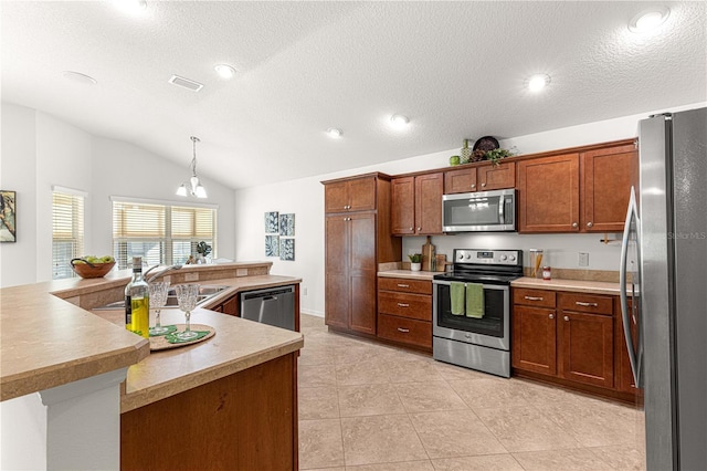 kitchen with pendant lighting, lofted ceiling, a textured ceiling, a notable chandelier, and stainless steel appliances