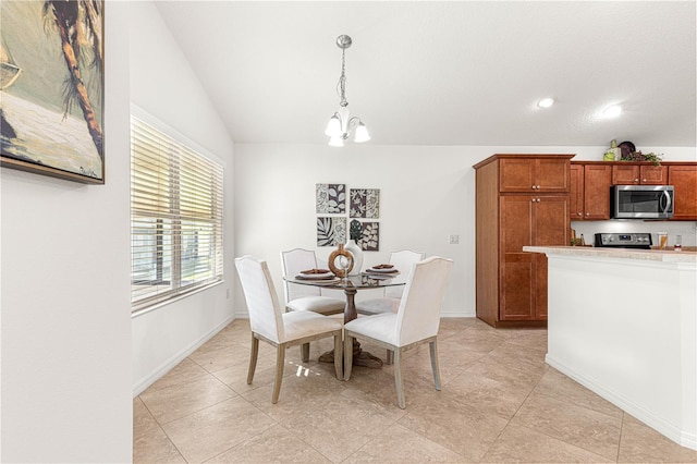 dining area featuring vaulted ceiling and a notable chandelier