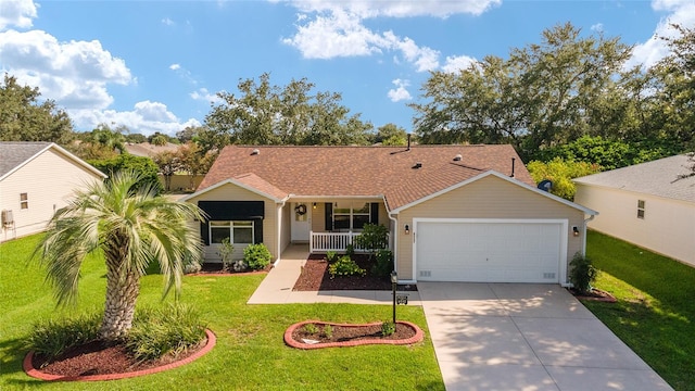 ranch-style home with a porch, a front yard, and a garage