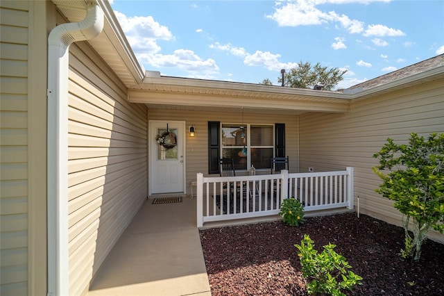 view of exterior entry with a porch