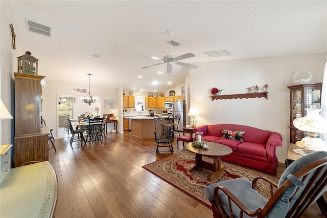 living room featuring hardwood / wood-style flooring, ceiling fan with notable chandelier, and lofted ceiling