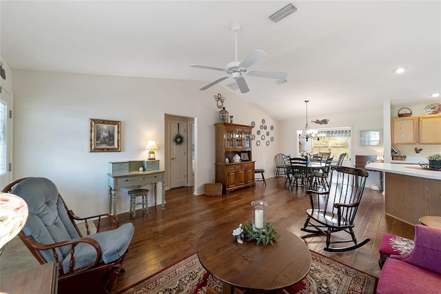 living room with lofted ceiling, ceiling fan with notable chandelier, and dark hardwood / wood-style flooring