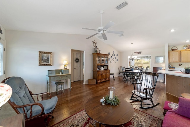 living room with dark wood-style floors, vaulted ceiling, ceiling fan with notable chandelier, and visible vents